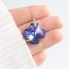 dije swarovski cruz del equilibrio heliotrope