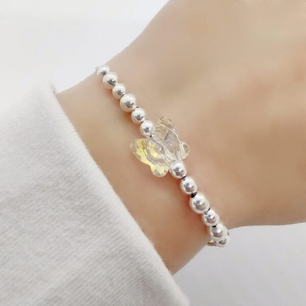 pulsera con bolitas y mariposa swarovski