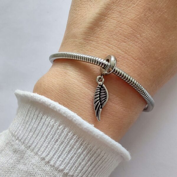 DCHA-99 Dije Charm Ala Acero Quirúrgico Plateado